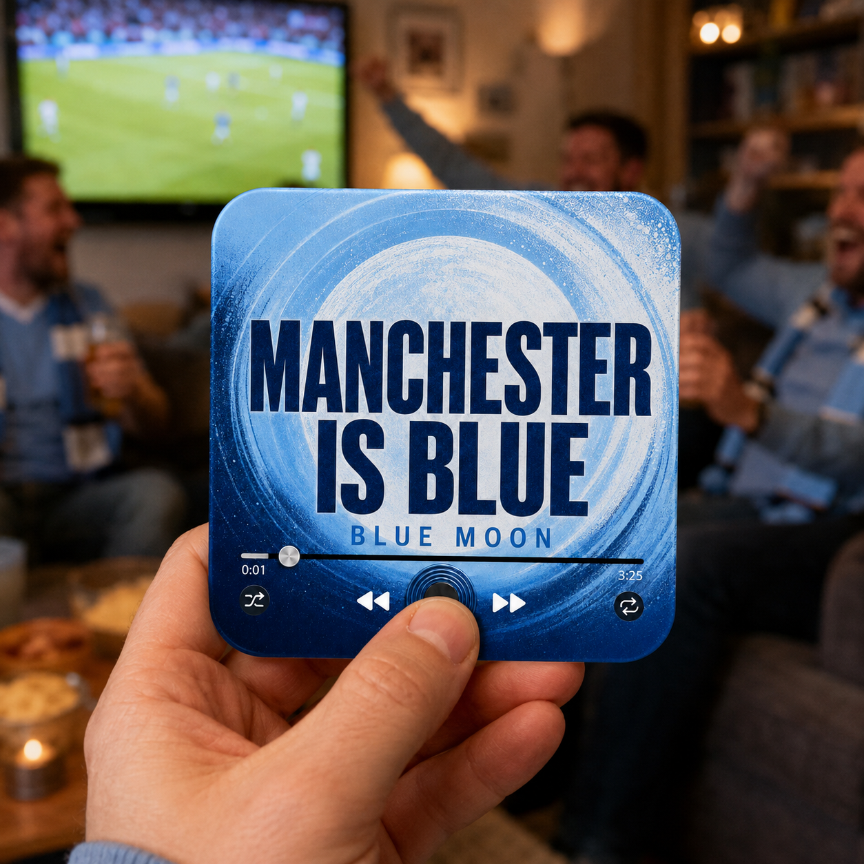 Manchester Is Blue Football Sound Magnet held in hand during a football match at home